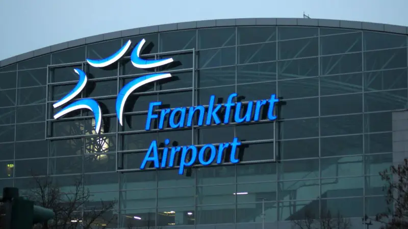 Main entrance to Frankfurt airport with illuminated lettering FRA Germany
