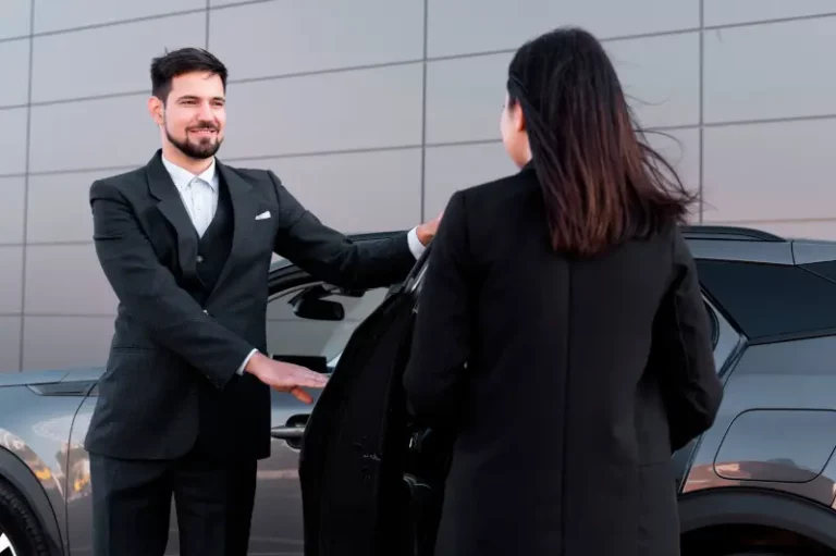 Chauffeur male open the door for a female customer foe transfer shuttle service